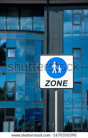 Street sign with a woman and a child for signalising a pedestrian zone, where bikes and cars are allowed to drive
