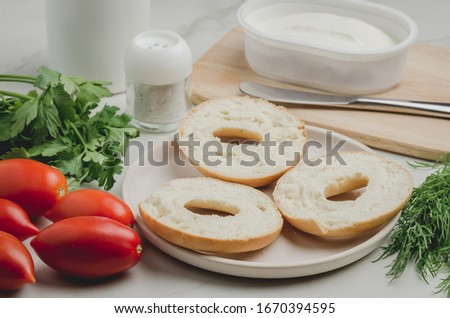 Healthy food with round toast, bottle, vegetables and cheese/Healthy food with round toast, bottle, vegetables and cheese on white table.