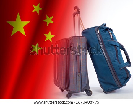 Suitcases next to the flag of China. Concept - a trip to China. Suitcases on a white background as a symbol of travel. A trip to PRC. Traveling at PRC. Tourism in the Peoples Republic of China