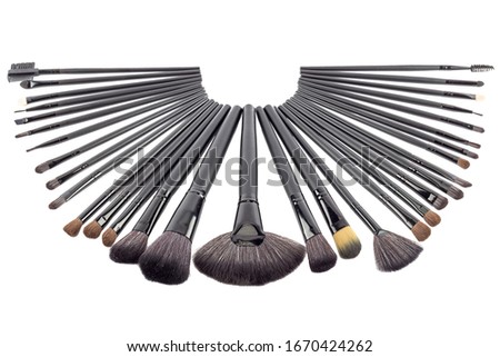 Black makeup brushes, beauty cosmetics, Blush, eyes shadow and contour, eyebrow comb, foundation, concealer, make up artist kit, isolated on white background, stock photography