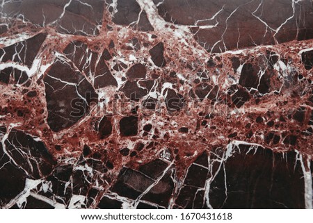 Burgundy marble with white streaks for background.