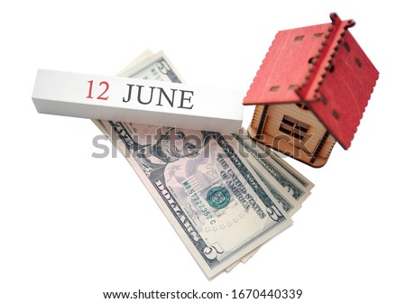 Money, home and calendar. The concept of financial independence and the scheduled start date for June 12