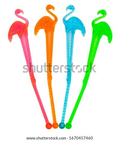 Isolated red, green, orange and blue plastic flamingo cocktail stirrers. Royalty-Free Stock Photo #1670457460