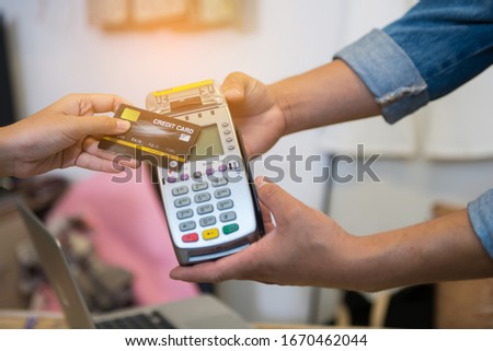 Close up Hand Swiping Credit Card In Store 
