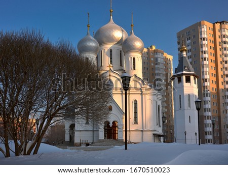 The Church of virgin Mary Icon Sign-Abalatsk on the street, Teachers in the winter in the snow. Russian architectural style, five-domed Church with crosses, tent bell tower, blue clear sky, bare trees