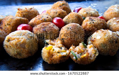 Deep Fried Risotto Balls with cherry tomatoes and basil