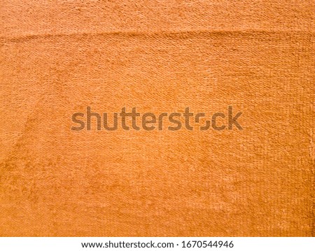 Orange towel background texture.Orange fabric surface.