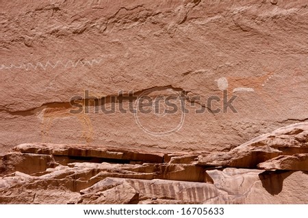 An image of carvings and ancient art on canyon walls