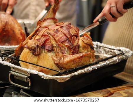 Picture turkey wrapped with bacon for thanksgiving dinner. Turkey with crispy bacon on top.