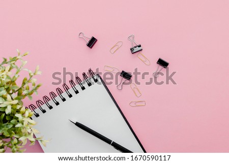 Stationary concept, Flat Lay top view Photo of pencil, pen  and notepad  on a pink abstract background with copy space, minimal style.

