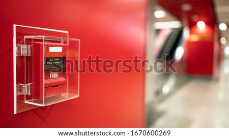Fire alarm on the wall in subway in Bangkok,  At the Bangkok subway fire warning equipment for emergency. It’s red fire alarm switch  on the wall. Founded un everywhere for the public area. 