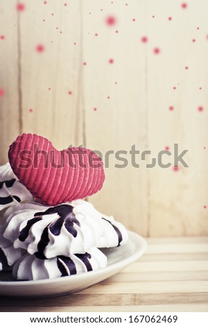 Meringue cookies and red heart/  Sweet holidays desert/ Valentines day background