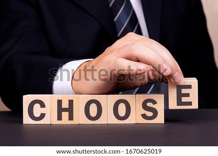 Man made word CHOOSE with wood blocks