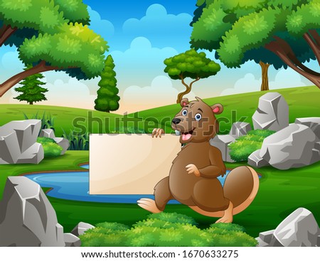 A beaver holding blank sign near the small pond