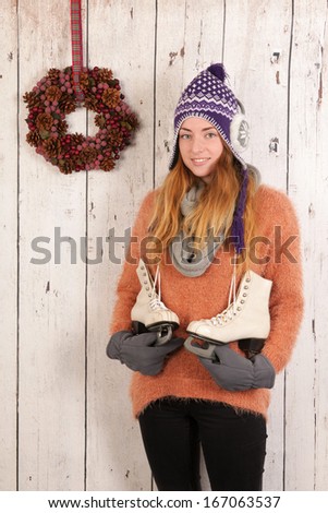 Portrait of woman in winter with pink hat and ice skates