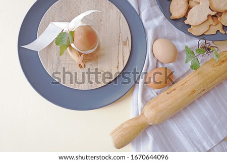         
Easter breakfast concept. an egg on a stand next to rabbit-shaped Easter pastries. flatley photo                       