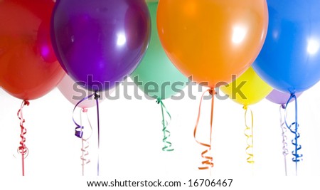 Close up of variety of balloons with ribbons brightly lit Royalty-Free Stock Photo #16706467