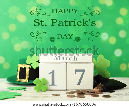 Composition with block calendar on white wooden table. St. Patrick's Day celebration