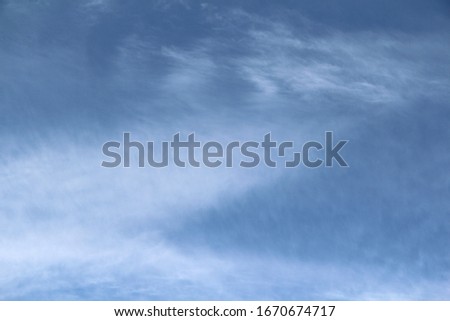 Cloudy blue sky with white and gray clouds. 