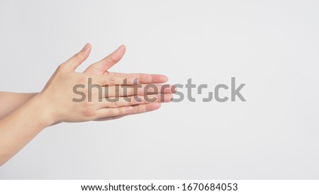 Male model is rubbing hand plams together on white background. Royalty-Free Stock Photo #1670684053