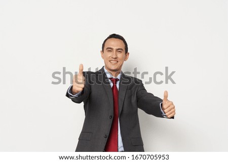 The man in the jacket is positive with a red tie model