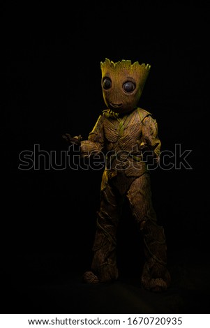 Big toy character, wooden costume tree with twigs and flowers