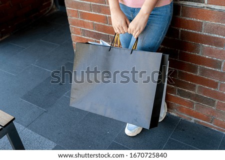 Young female holding two bag, mockup blank screen paper shopping bag with clipping path, Empty space on shopping bag for design insert logo or graphic.