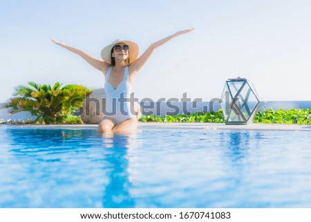 Portrait beautiful young asian woman happy smile relax around outdoor swimming pool in hotel resort for leisure vacation
