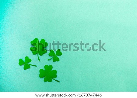 Four Green clover on a blue background flat lay, copy text.