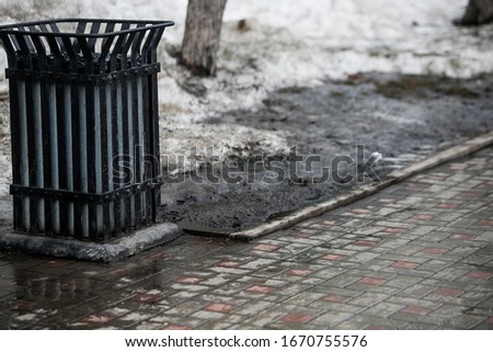 Spring, snow melting. Dirty, wet and slippery pedestrian walkways and city roads