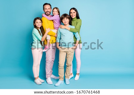 Full length body size view of nice attractive lovely adorable tender sweet gentle cheerful cheery family teenage hugging growing-up isolated on bright vivid shine vibrant blue color background