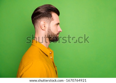 Close-up profile side view portrait of his he nice attractive calm content bearded guy in casual formal shirt trendy look haircut isolated on bright vivid shine vibrant green color background