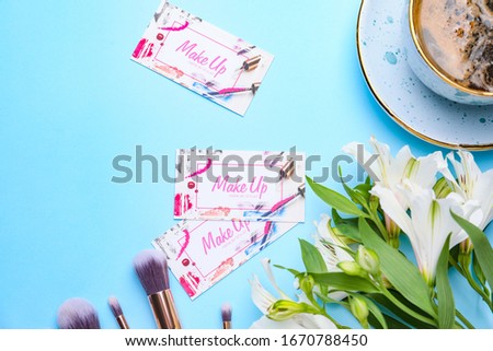 Business cards of makeup artist on color background