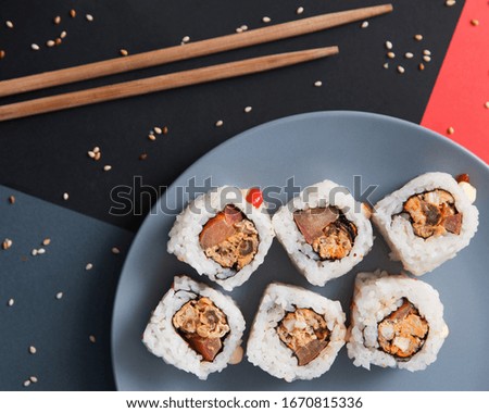 Japanese food. Rolls in grey plate on dark background.