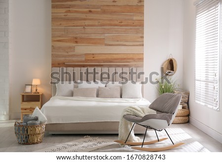 Stylish room interior with big comfortable bed Royalty-Free Stock Photo #1670828743