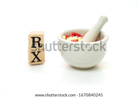 RX with Mortar and Pestal with red and yellow pills isolated on white background. Mortar and RX symbol using as pharmacy concept.