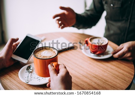 Two persons discussing business projects in a cafe while having coffee. Startup, ideas and brain storm concept Royalty-Free Stock Photo #1670854168