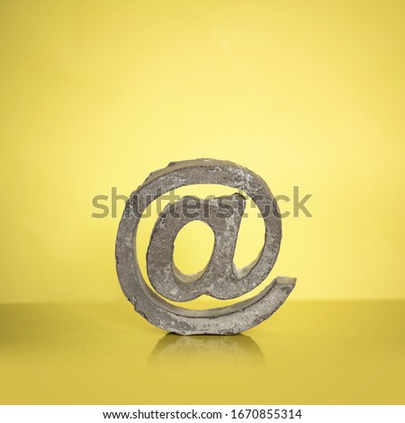 cement at-sign & yellow background