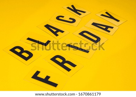 Selective focus word black friday on yellow background , shopping sale concept, Flat lay design of Black Friday Sale text, Online shopping concept, advertising for seasonal promotion