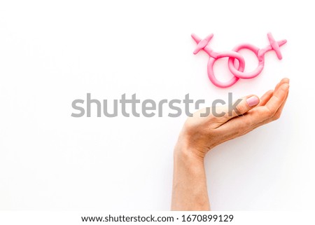 LGBT concept. Female Venus symbols in hands on white background top-down copy space