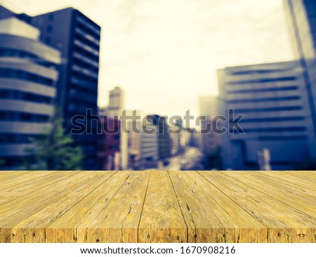 image of wood table and blur building in Japan for background.