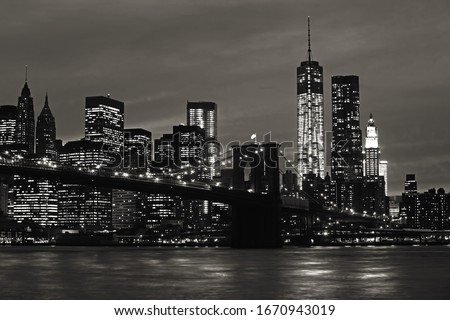 Manhattan and Brooklyn Bridge at night. Black and white image
