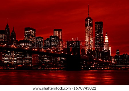 Manhattan and Brooklyn Bridge at night. Image in the dramatic red colors
