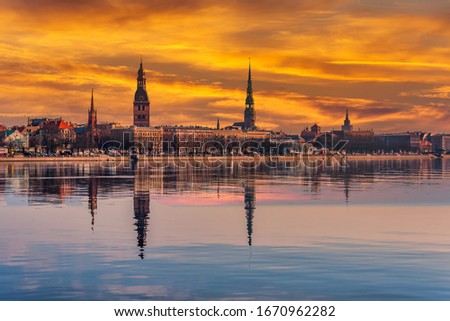 Cityscape of Riga Latvia with Reflections on a Quiet Still River at Sunset Royalty-Free Stock Photo #1670962282