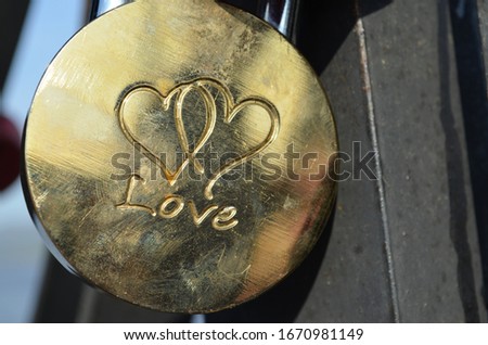 Gold-colored padlock with inscription and engraving