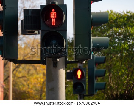 Row of red traffic lights for pedestrians, shallow focus.