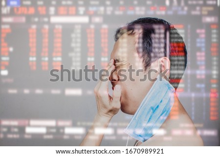 Asian man got frustrated and angry after Stock market surge and dramatically fall down as a result of Coronavirus or covid19 fears and world oil price decrease. All world economic get worse Royalty-Free Stock Photo #1670989921