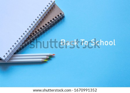 Set of stationery items on blue background. Flat lay
