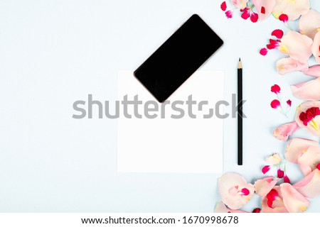 Picture for womens blog. Flat lay with flowers, notebook, smartphone and pencil on paper background