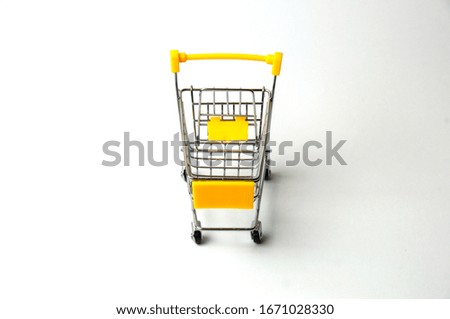 Cart for shopping yellow on a white background. Concept holiday shopping, sales, prices and discounts.